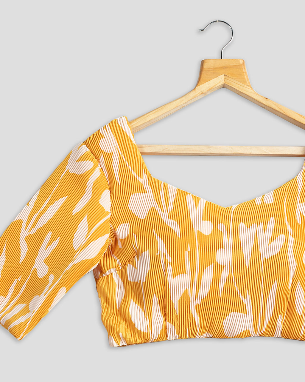 Blusa plisada floral amarilla