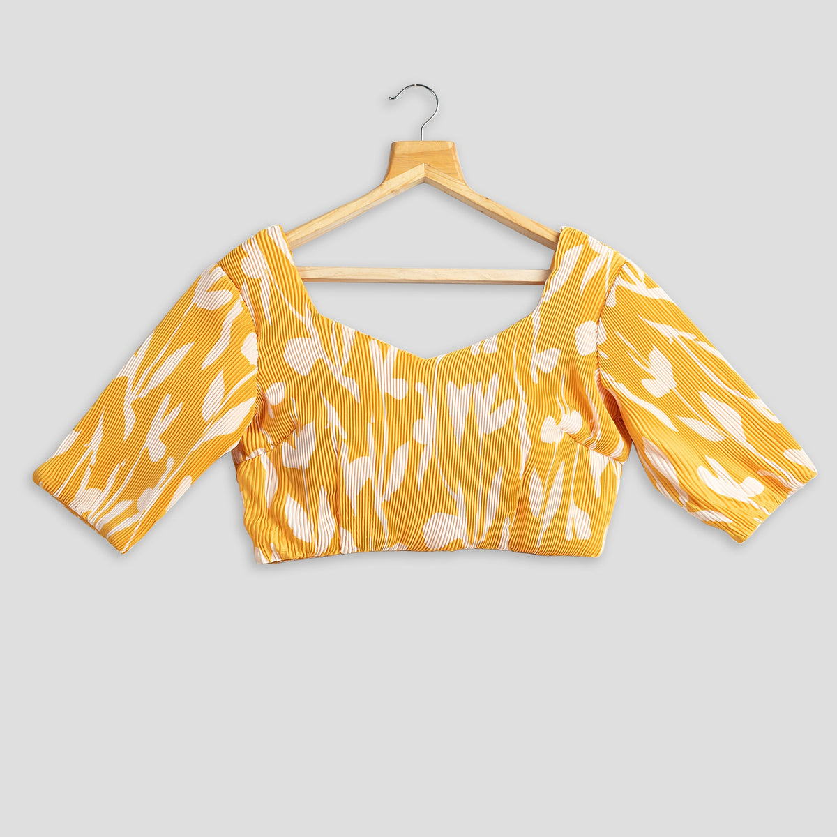 Blusa plisada floral amarilla